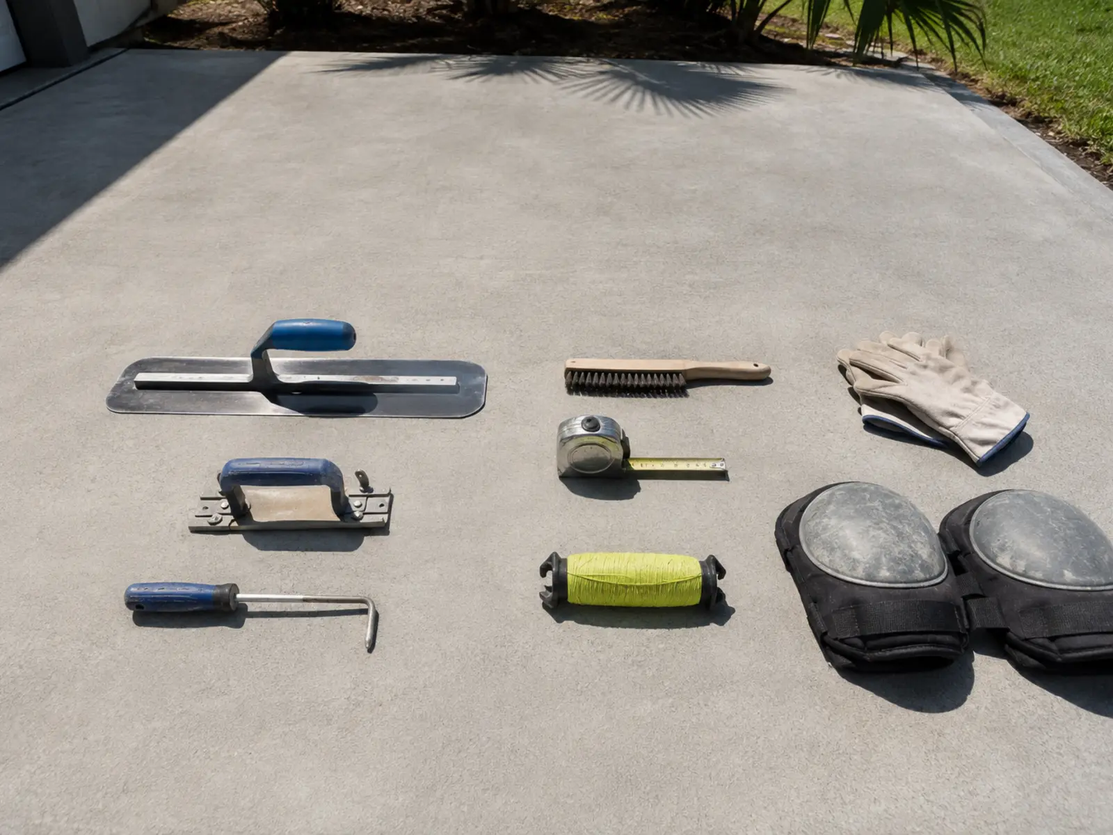 Concrete finishing tools laid out on a finished slab